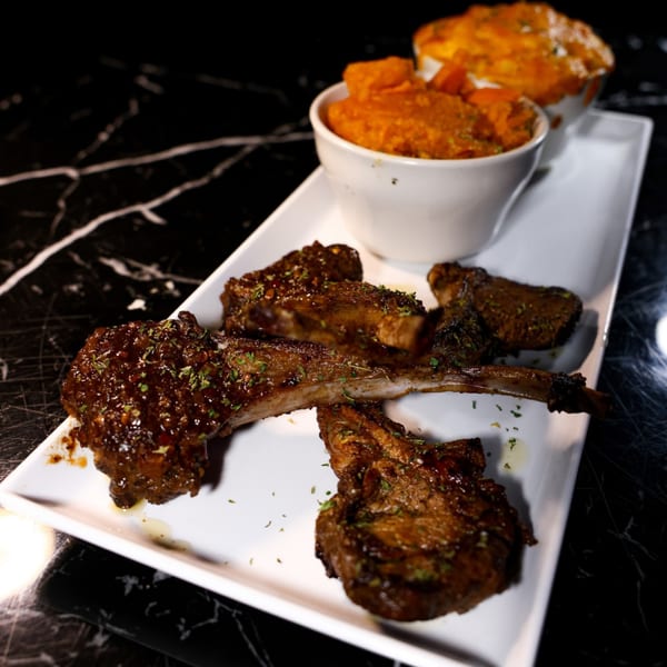 The L Station's glazed lamb chops with a side of sweet potato mash and mac and cheese.